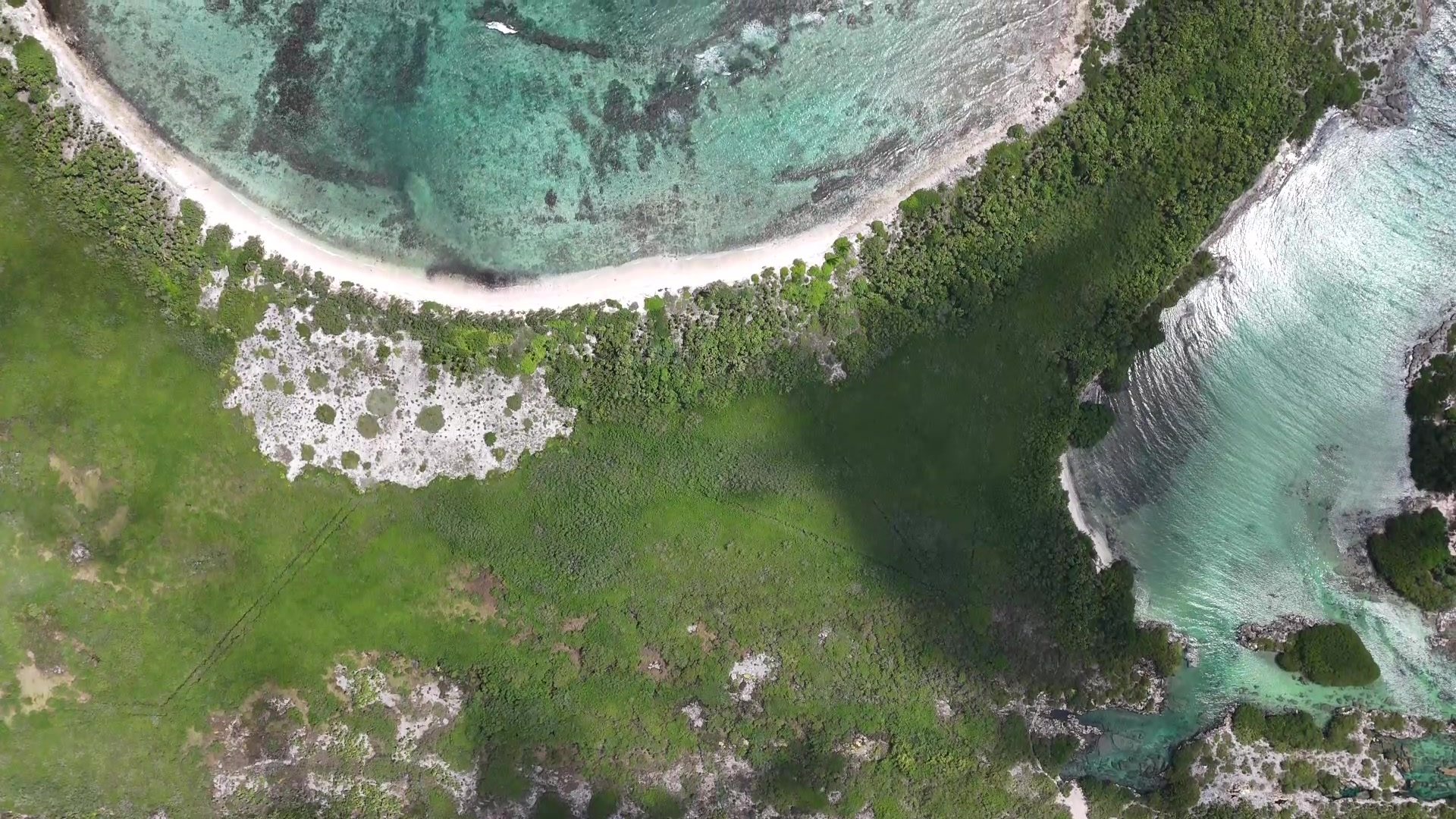 Aerial view of the beach curve and shallow reef seen from above